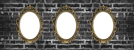 vintage golden frames with copy space hanging on the dirty brick wallの写真素材