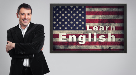 Learning english concept. Cheerful young businessmanの写真素材