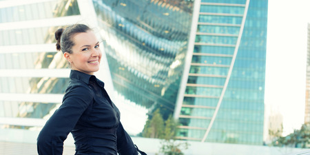 outdoors portrait of smiling business woman looking at cameraの写真素材
