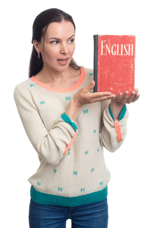 English language learning. Woman holding an English textbook over white backgroundの写真素材