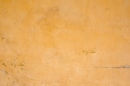 Background of old yellow stained wall. Grunge texture