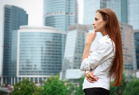 beautiful woman standing near skyscrapers. Business Centreの写真素材