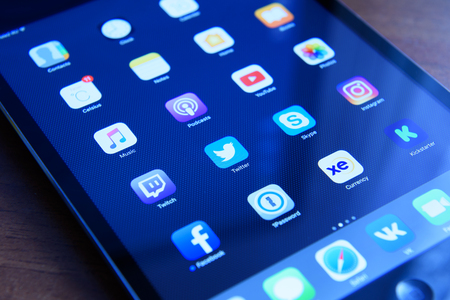 Moscow, Russia - September 16, 2016: social media network and over programs known brands on the screen iPad from Apple.のeditorial素材