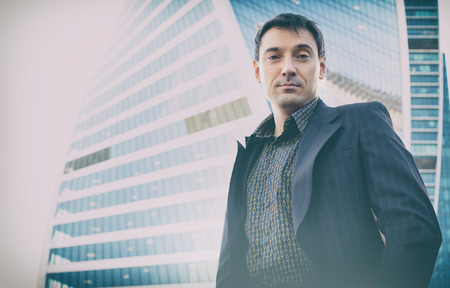 outdoor portrait of successful businessman. Business man on the street near the office building