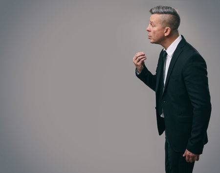 Senior business man talking with someone. Studio shotの写真素材