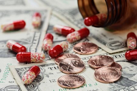 Drugs on money close up. Medical pills and tablets