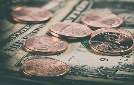 macro of coins and us dollars close up
