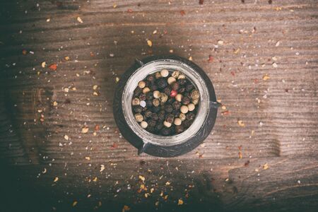 Spices. black peppercorns on wooden table. Top view