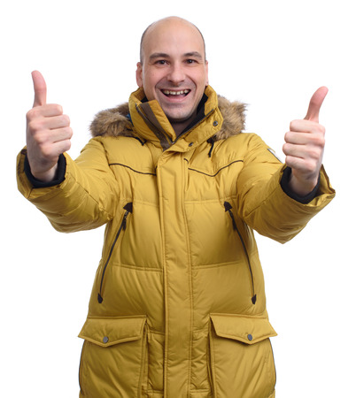 guy wearing a yellow winter jacket isolated on white backgroundの写真素材