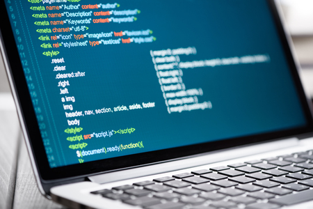 HTML Code on laptop screen. Web Design Concept.