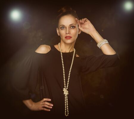 portrait of a fashionable beautiful woman. Dark backgroundの写真素材