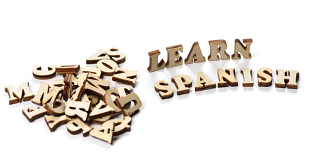 learn spanish concept. wooden letters on a white backgroundの写真素材