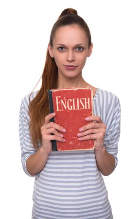 Learning English concept. Pretty girl holding a book. Isolatedの写真素材