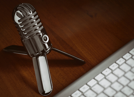retro style microphone with modern keyboard on a desk. Podcast conceptの写真素材