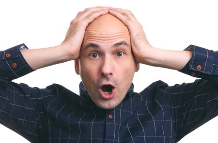 shocked bald guy holds his head in hands. hair loss. Isolated
