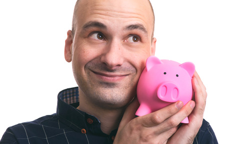 Happy man holding piggy bank isolated on white background. Financial security planning conceptの写真素材