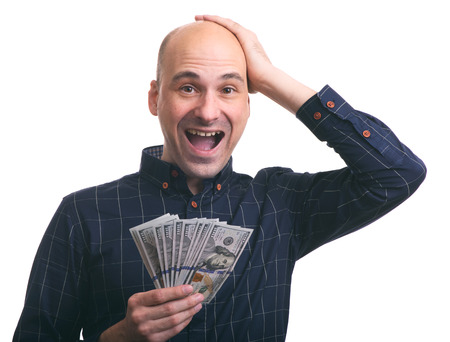 Surprised happy man holds a lot of money. Isolatedの写真素材