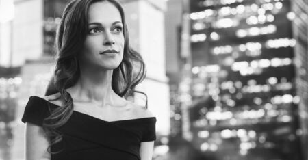 Portrait of a beautiful business woman in the street of big cityの写真素材