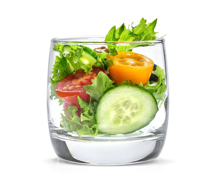 vegetable salad in a glass. Isolated on whiteの写真素材