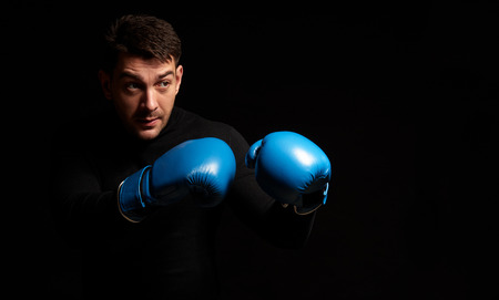 man boxing on black background. Isolated with copy spaceの写真素材