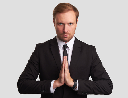 attractive young man meditating. Serious business person looking at camera. Isolatedの写真素材