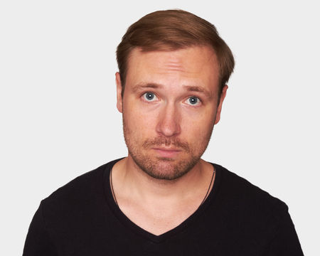 handsome young man wears black t-shirt. Isolated on gray backgroundの写真素材