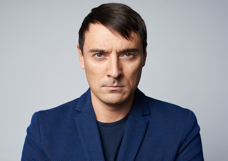 Middle aged handsome man with serious expression on his face. Studio shot