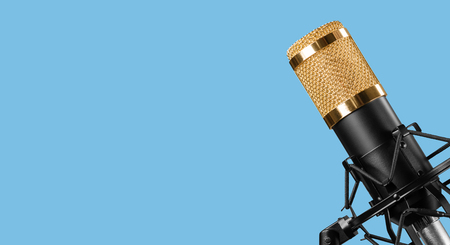 professional microphone isolated on a blue backgroundの写真素材