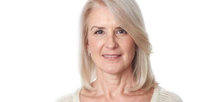 Happy old lady face. Close up portrait of a senior woman. Isolatedの写真素材