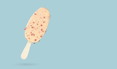 White chocolate ice cream bar ice cream with nuts isolated on blue background