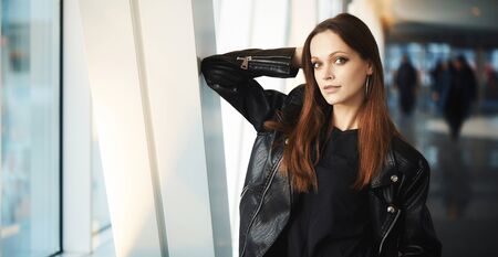 Beautiful young woman is wearing casual clothes. Urban portrait