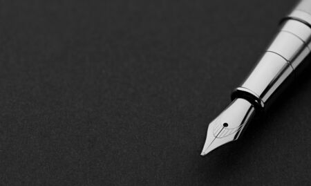 close up of a fountain pen on a black paper with copy spaceの写真素材