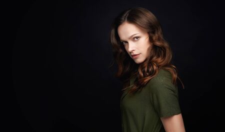 Beauty woman face. Beautiful model with natural makeup isolated on black