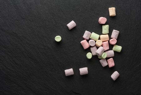 colorful marshmallows on a slate stone board. Top viewの写真素材