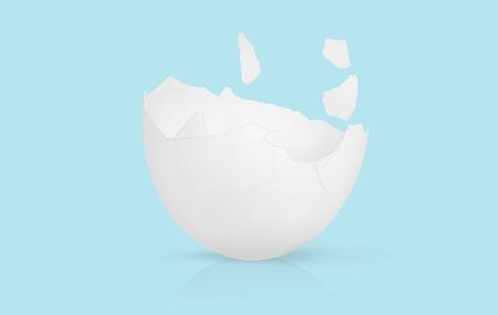 Broken eggshell isolated on blue backgroundの写真素材