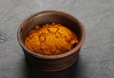 Dry turmeric powder in a bowl. Curcum longa Lynnの写真素材