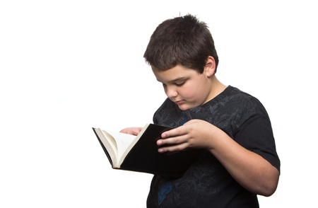 Boy reading book isolated on white の写真素材