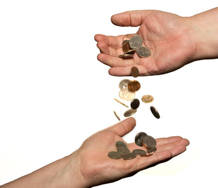 Coins dropping from on hand to another isolated  on white 