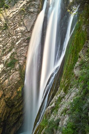 Water falling among the rocks and stonesの写真素材