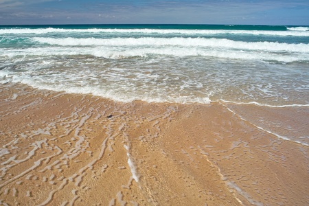 Ocean waves an the sandy beach