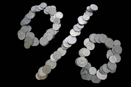 percent sign made of coins  isolated on blackの写真素材