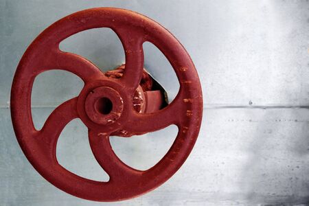 red rusty gauge wheel on silver backgroundの写真素材