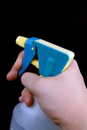 hand pressing the trigger of household sprayer
