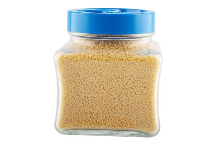 jar with the millet cereals on whiteの写真素材