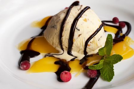 ice cream with frozen berries and sauceの写真素材