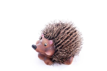 ceramic hedgehog figurine with textile needlesの写真素材