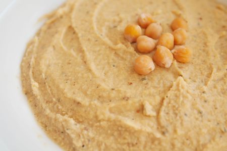 hummus spread on the table decorated  with boiled chickpeasの写真素材