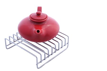 red ceramic teapot on grillの写真素材
