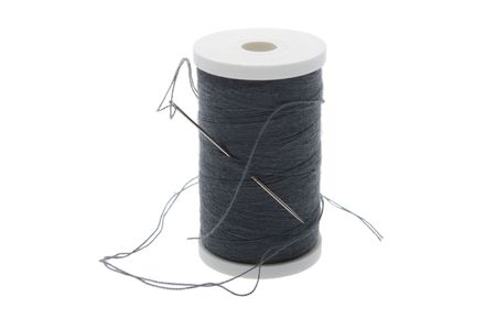 gray sewing thread reel with needle