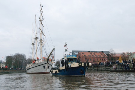 KLAIPEDA, LITHUANIA  NOVEMBER 10: Klaipeda city symbol barquentine "Meridianas" on her way to the major overhaul and tugboat on November 10, 2012 in Klaipeda.のeditorial素材